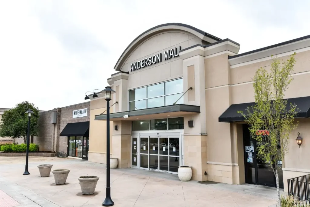 Entrance to Anderson Mall with people walking in and out of stores.