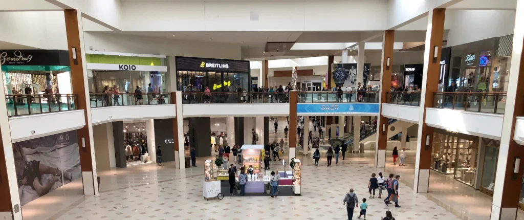 A bustling Aventura Mall, filled with numerous people strolling around inside.