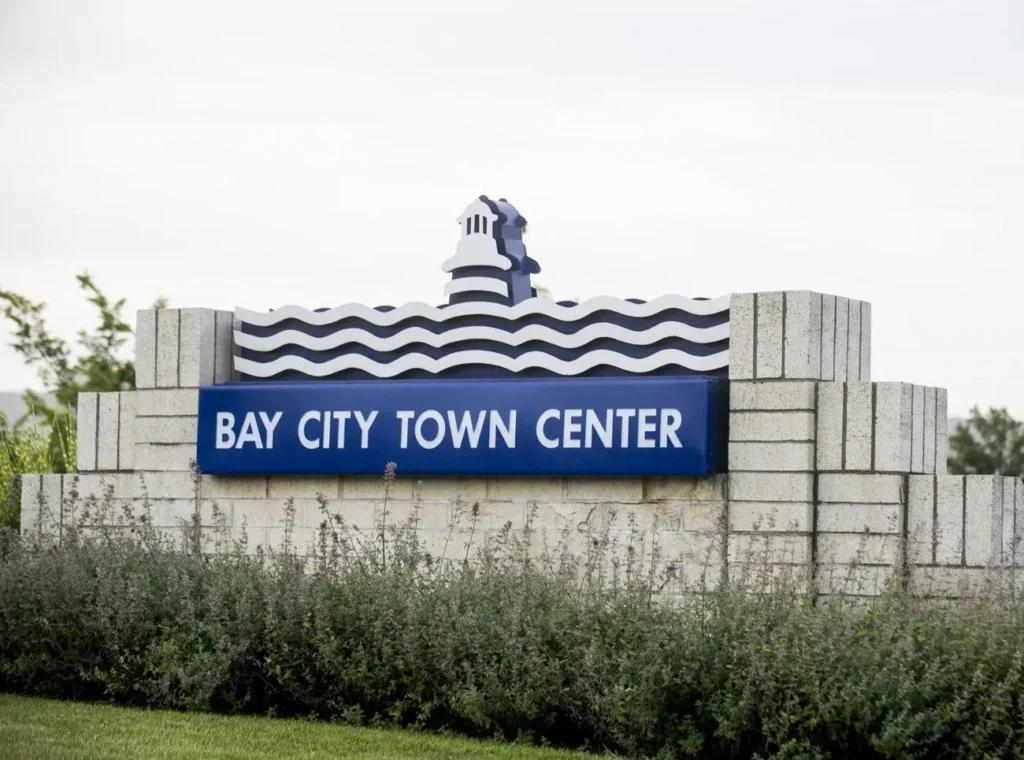 Sign for Bay City Town Center, featuring modern design and vibrant colors.