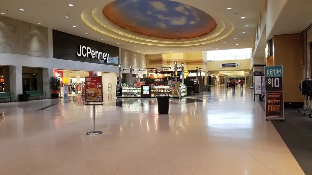 Exterior of Chapel Hill Mall with colorful storefronts and people walking around.