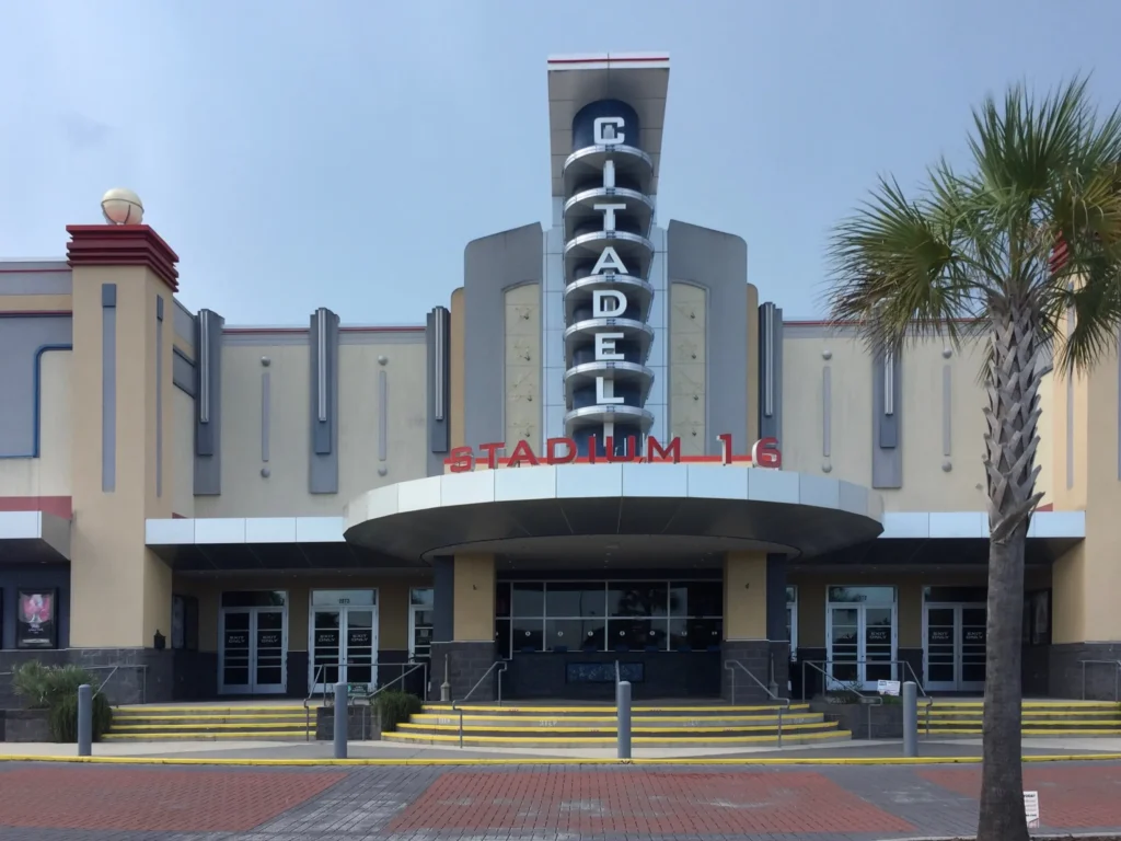 Front of Citadel Mall movie theater with palm trees.