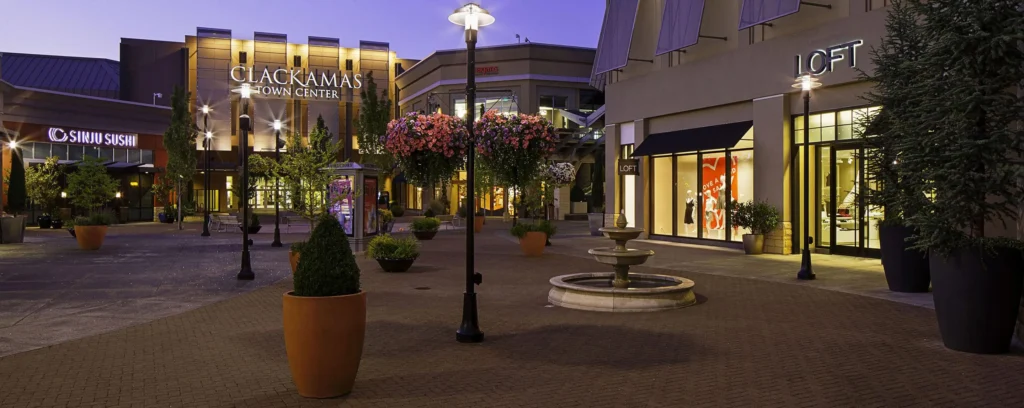 A charming street with a fountain and shops at Clackamas Town Center.