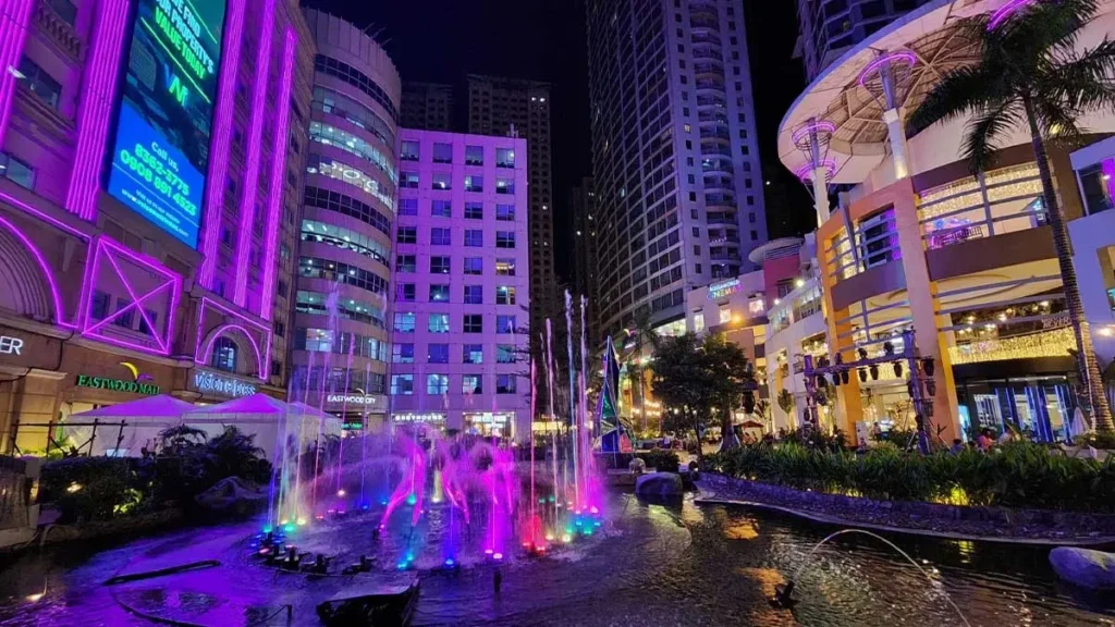 A vibrant city fountain at Eastwood Mall, illuminated by mesmerizing purple lights.