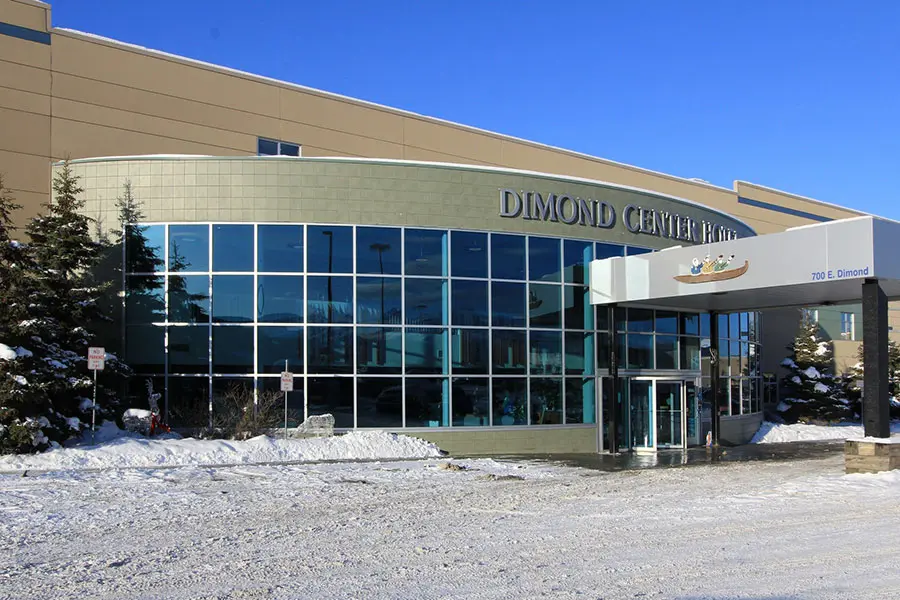 Aerial view of Dimond Center, a shopping mall in Alaska. Shoppers walking through various stores and restaurants.