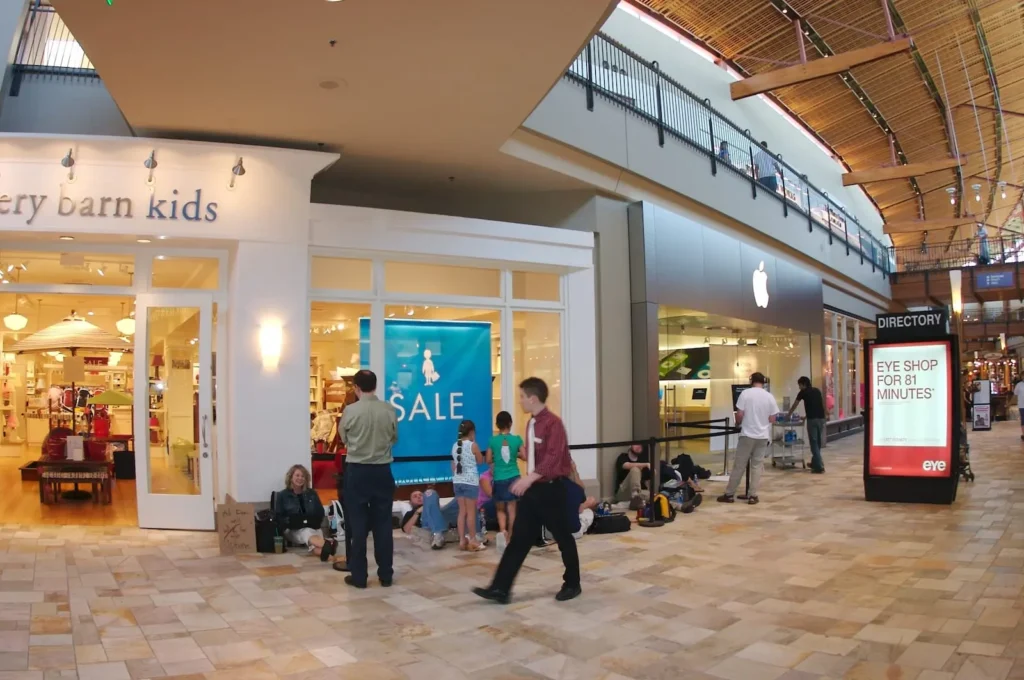 People walking in FlatIron Crossing mall with shops and stores.