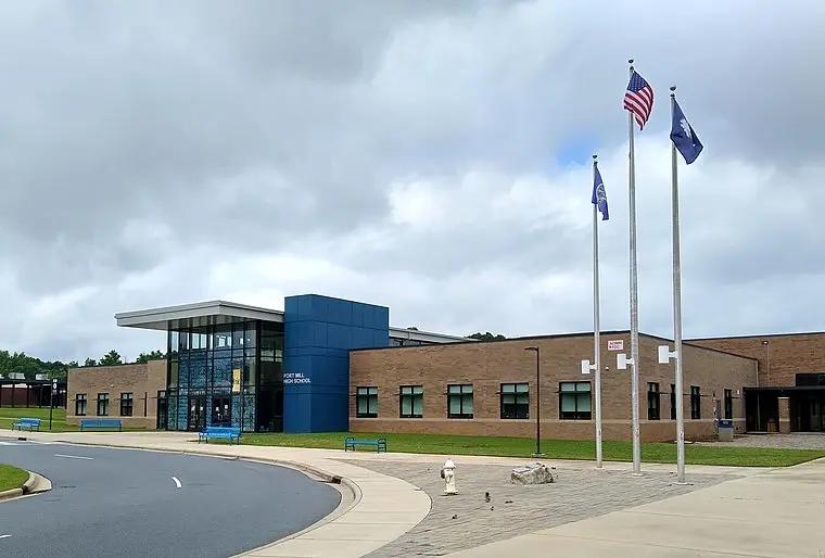 A large building with flags flying in front of it at Fort Mill Square.