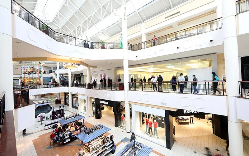 Interior of Francis Scott Key Mall showing various stores and shoppers browsing.