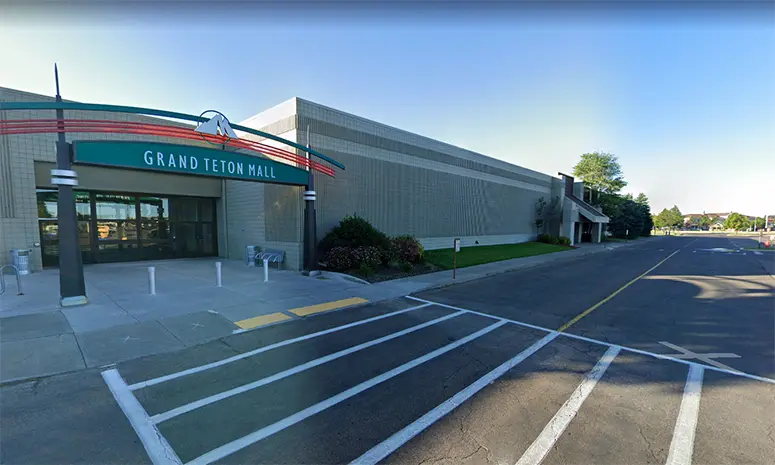 Exterior of Grand Teton Mall with various stores and shoppers walking around.