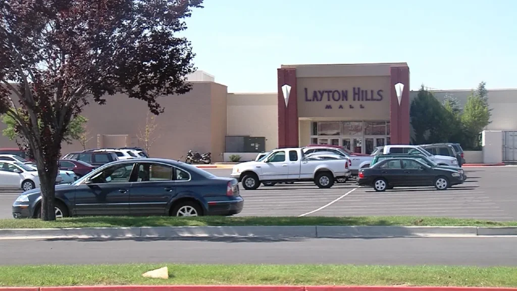 Exterior view of Layton Hills Mall with people walking in and out of the entrance.