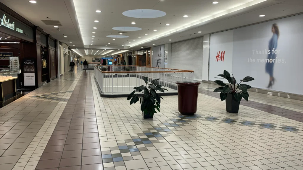 Meriden Mall, featuring a spacious tiled floor adorned with numerous plants.