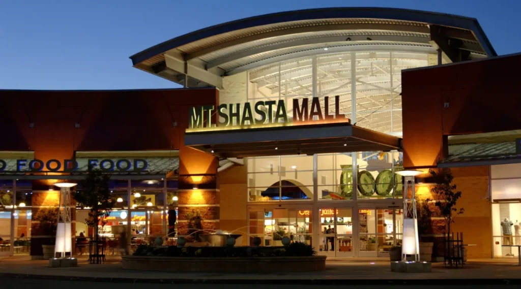 Exterior of Mount Shasta Mall showcasing shops and surrounding landscape.