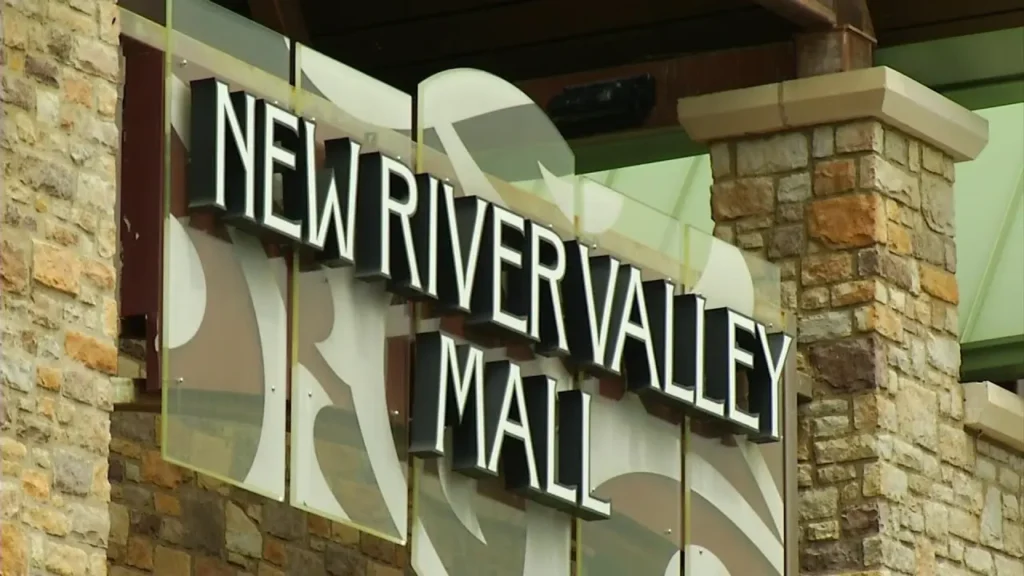 Exterior of New River Valley Mall with large glass windows and colorful signage.