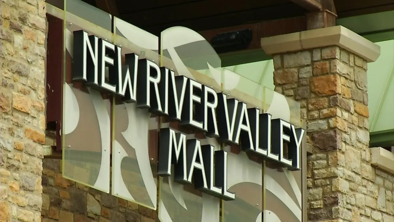Exterior of New River Valley Mall with large glass windows and colorful signage.