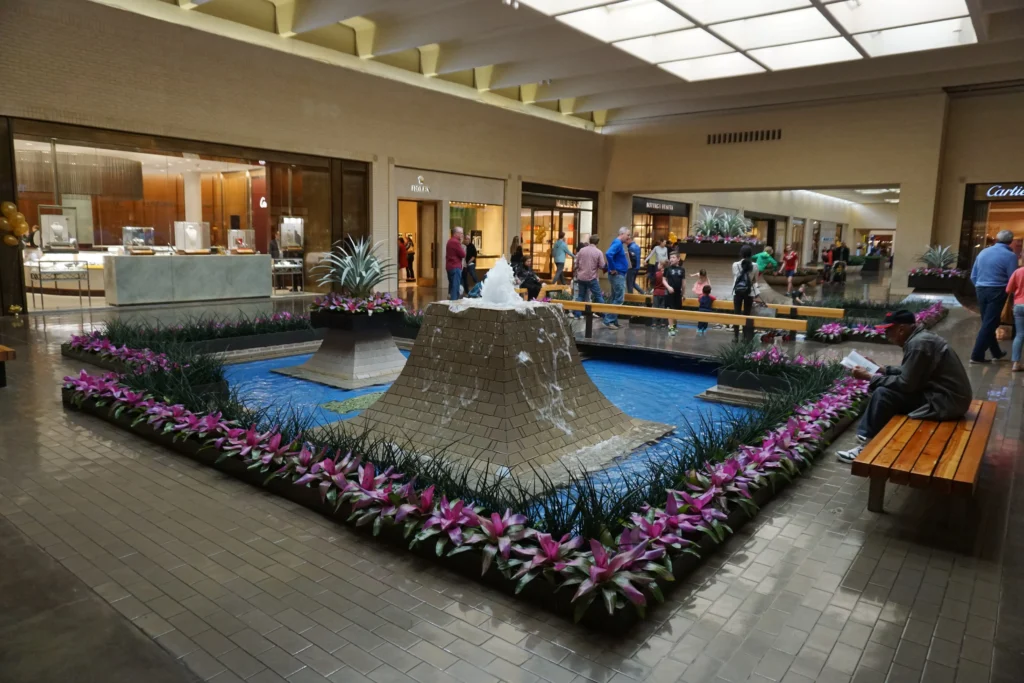 Exterior of Northpark Mall with people walking in and out of the entrance.