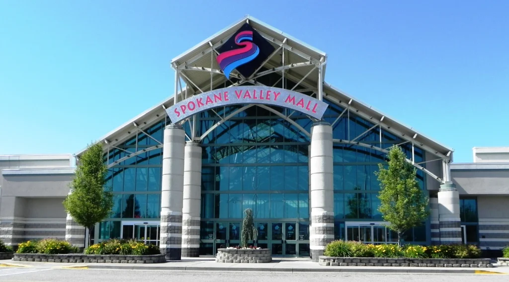 Front entrance to large building with sign "Swan Valley Mall" in Spokane Valley Mall.