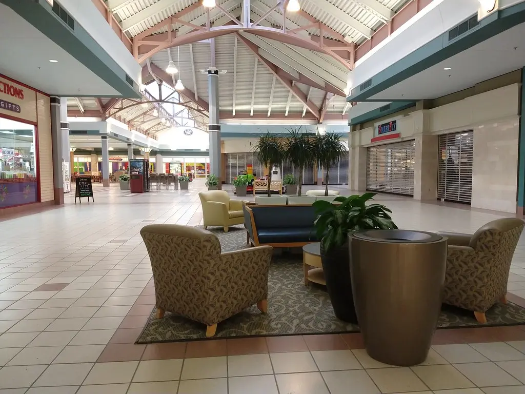 Interior of Steeplegate Mall with chairs and tables in the center.