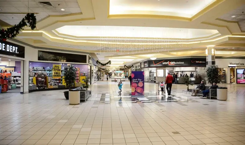 Interior of Susquehanna Valley Mall with various stores and shoppers walking around.