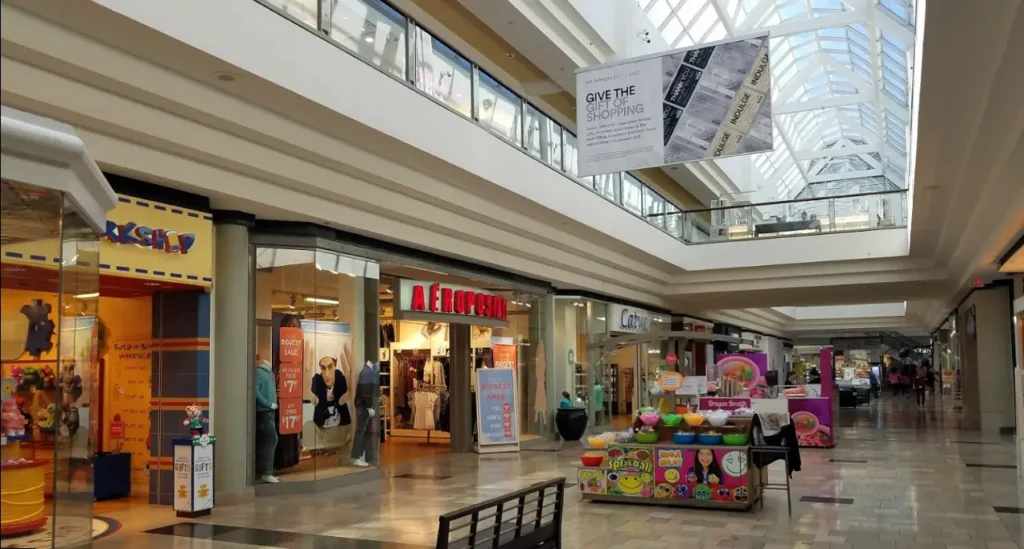 A bustling mall with various shops and stores at The Avenues.