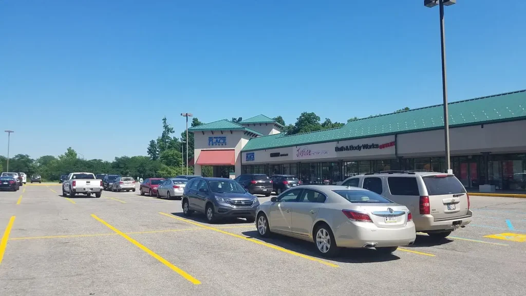 A parking lot filled with parked cars at The Outlet Shoppes at Fremont.