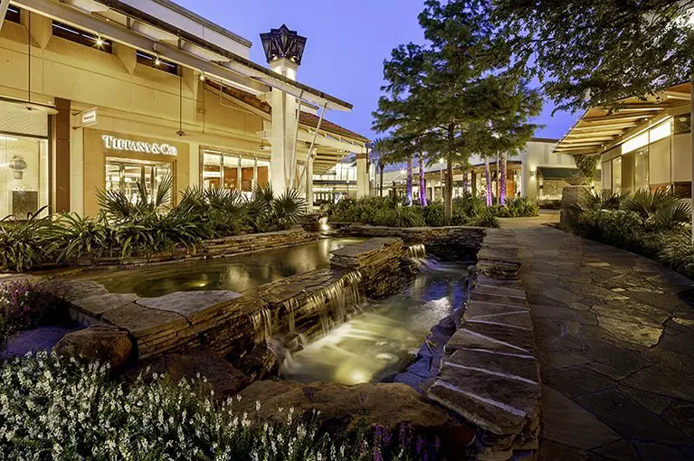 Busy shopping mall scene with modern architecture, busy shoppers, and a lively atmosphere.