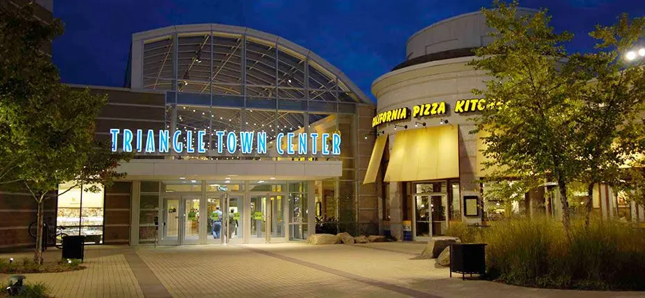 The entrance to Triangle Town Center mall at night: a brightly lit gateway leading to a world of shopping and entertainment.