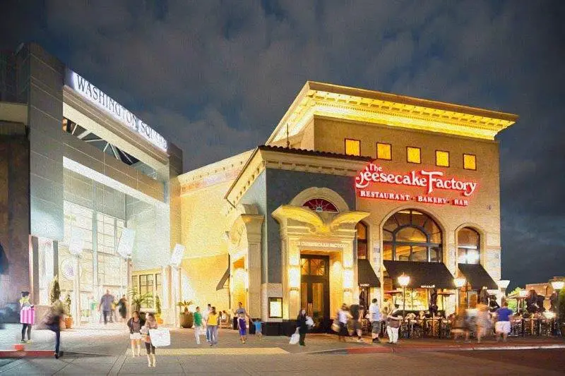 Exterior view of Washington Square Mall with people walking around and shopping.