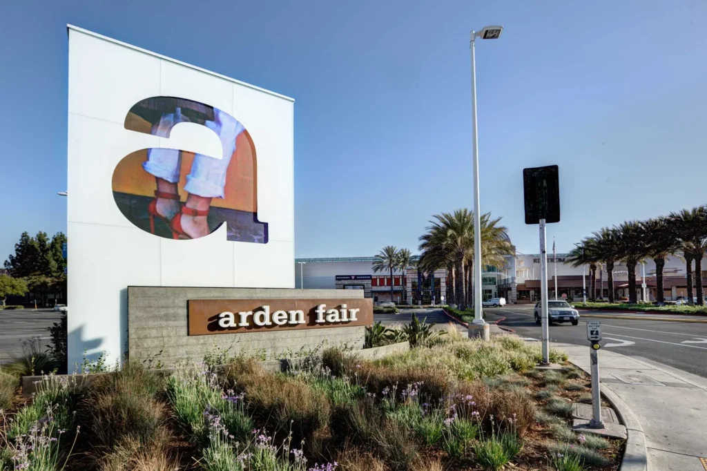 Arden Fair Mall sign in front of a building.