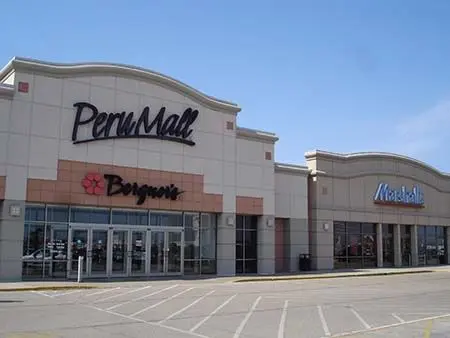 Retail store with spacious parking lot and prominent sign.