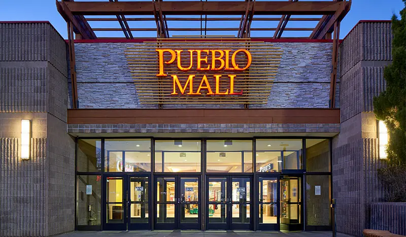 Entrance to a store with a sign saying "Pubo Mall" - a vibrant shopping destination.