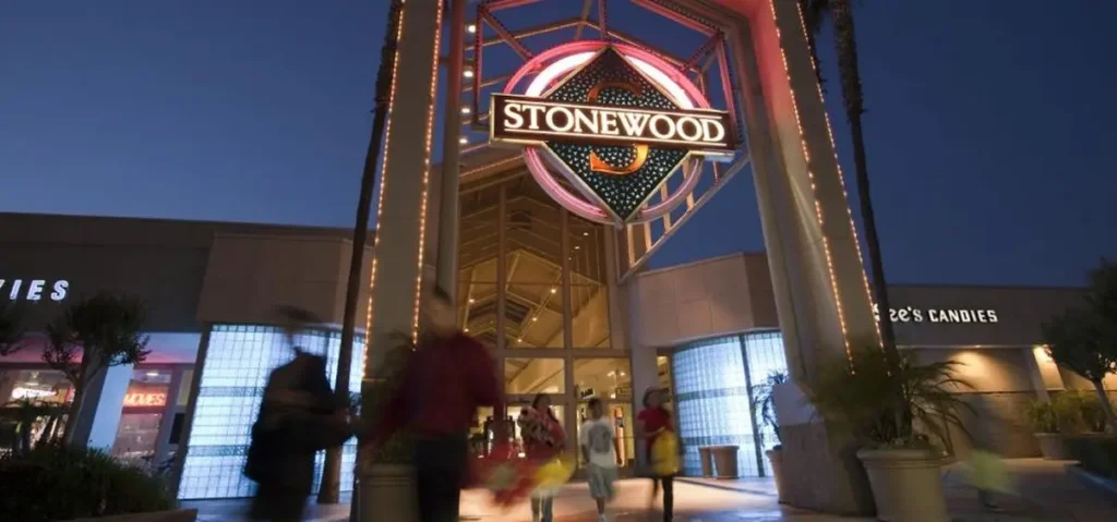 Stonecrest Mall in San Diego, a modern shopping center with palm trees and clear blue skies.