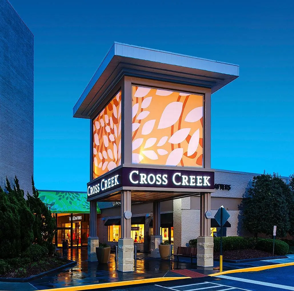 Exterior view of Cross Creek Mall in Atlanta, showcasing a modern shopping center with various stores and a spacious parking lot."