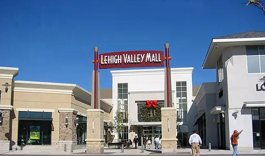 A tall building with a sign on top.