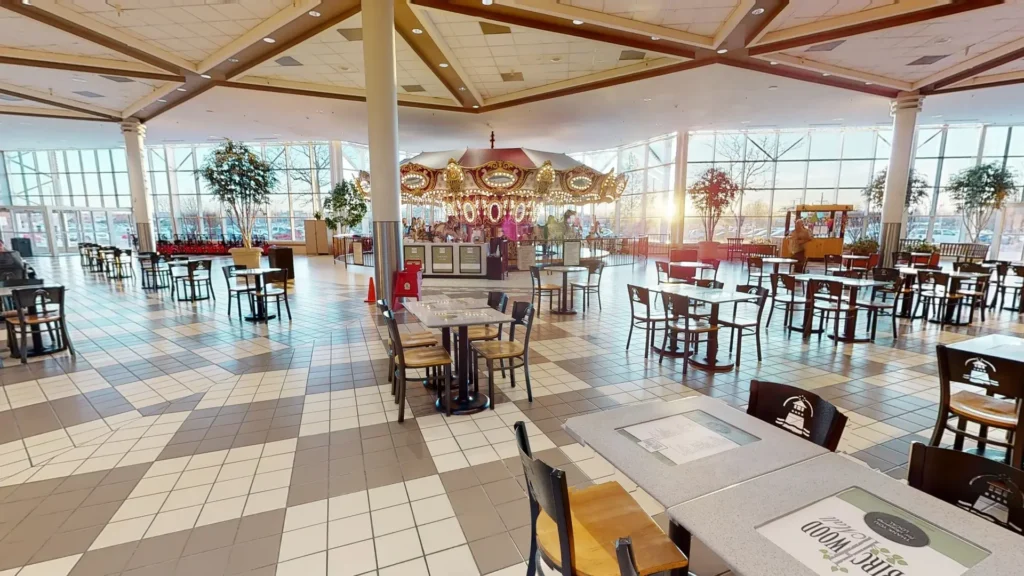 Interior of Birchwood Mall restaurant with tables and chairs.