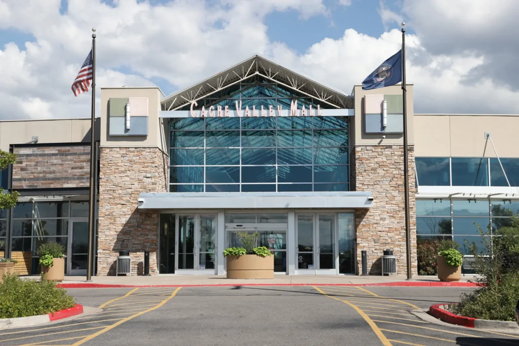 Front entrance to Cache Valley Mall with flag pole.