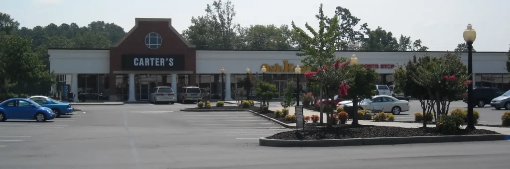 Car dealership at Calhoun Outlet Marketplace Mall parking lot.