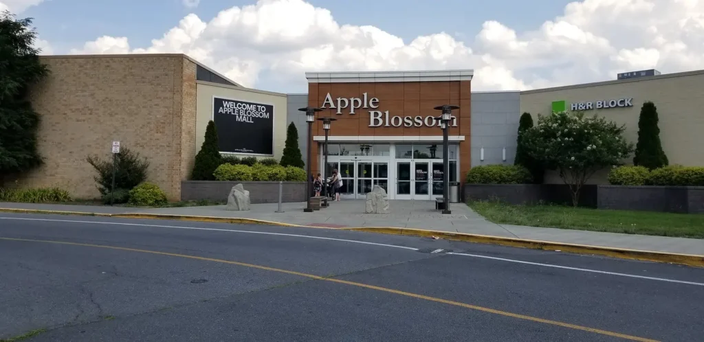 A bustling shopping center with a variety of stores, restaurants