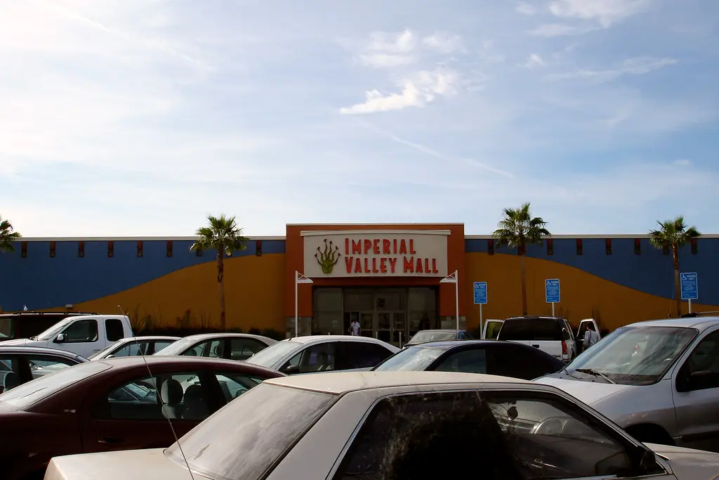 A parking lot filled with cars at Imperial Valley Mall.