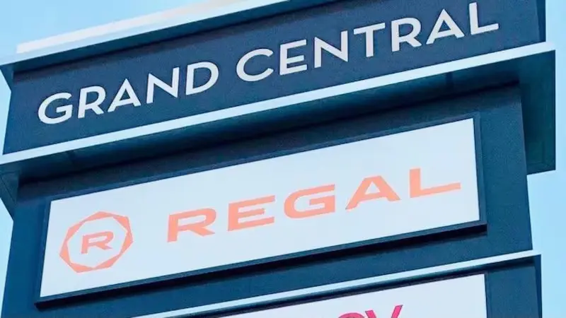 Sign for Grand Central Regal Movie Theater, featuring elegant gold lettering on a black background.