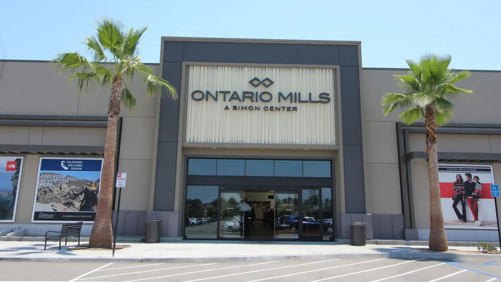 Exterior view of Ontario Mills Mall with multiple stores and palm trees in the background.