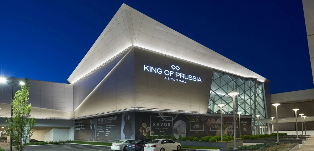 Exterior of modern building at King of Prussia Mall illuminated at night.