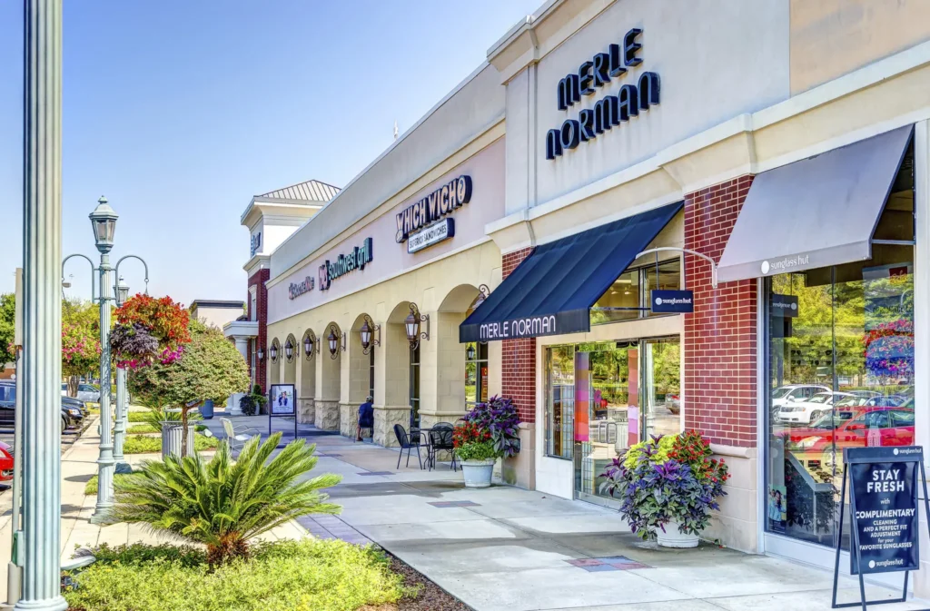 The Shoppes at Eastchase Mall with palm trees and people walking around