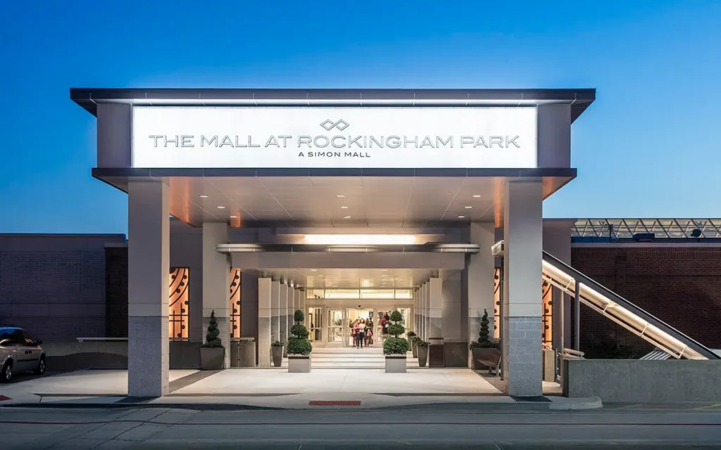 The Mall at Rockingham Park sign in front of a vibrant blue sky.