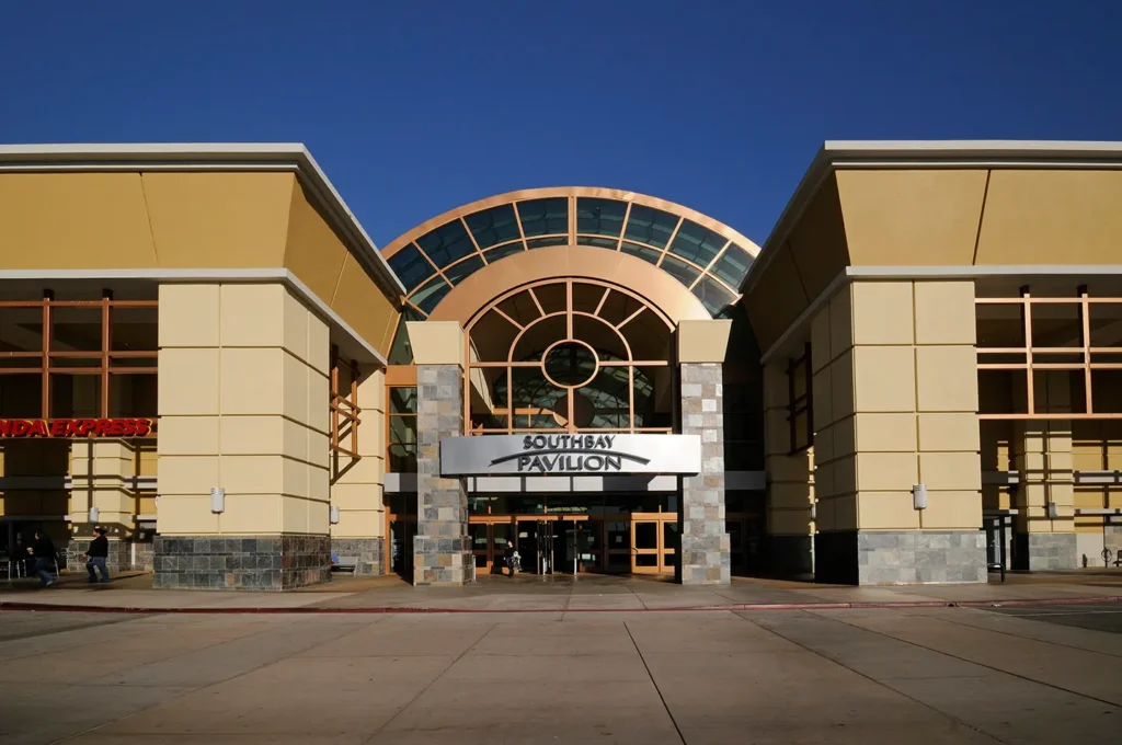 A bustling shopping center with a variety of stores, restaurants