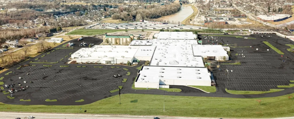 Aerial view of Piqua Mall with various stores and parking lot.