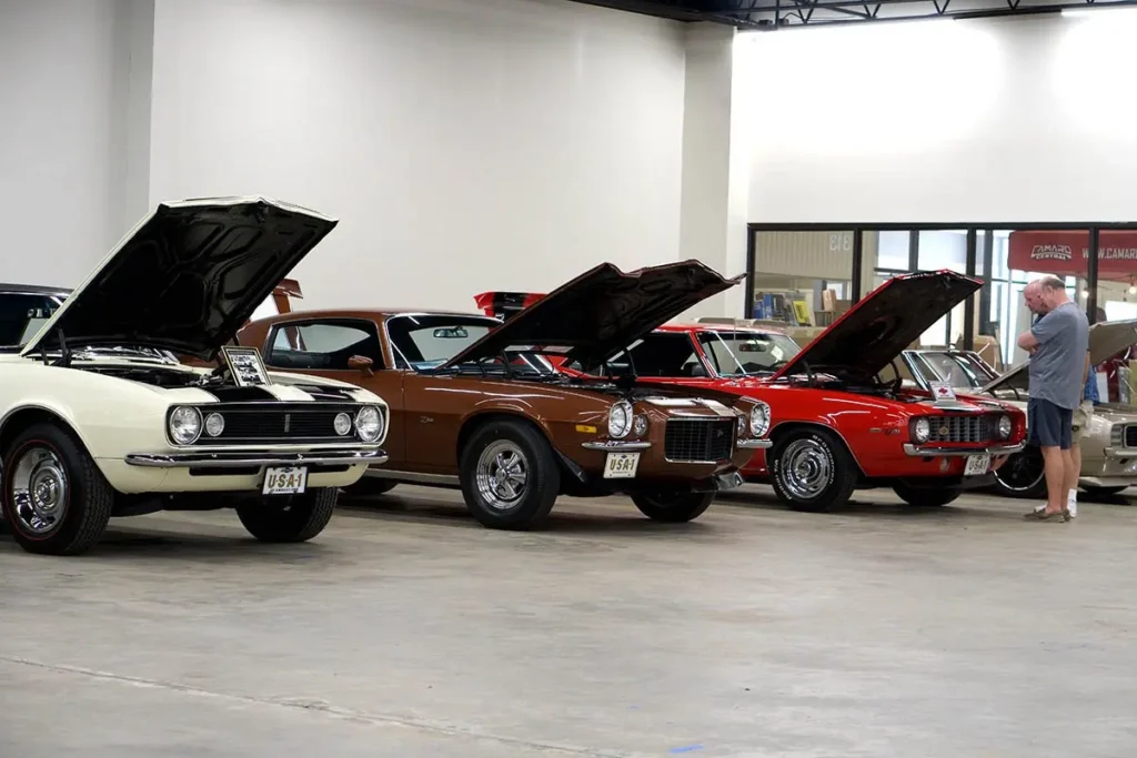 A man inspecting a car in a garage at Classic Auto Mall