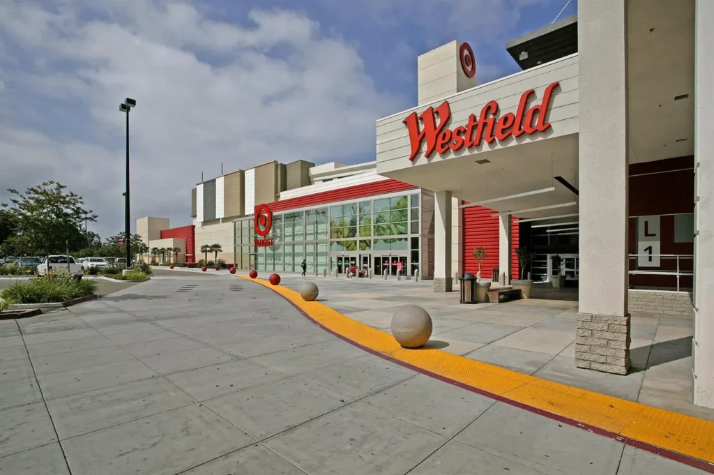 Westfield Plaza Bonita Mall with palm trees and people walking around.