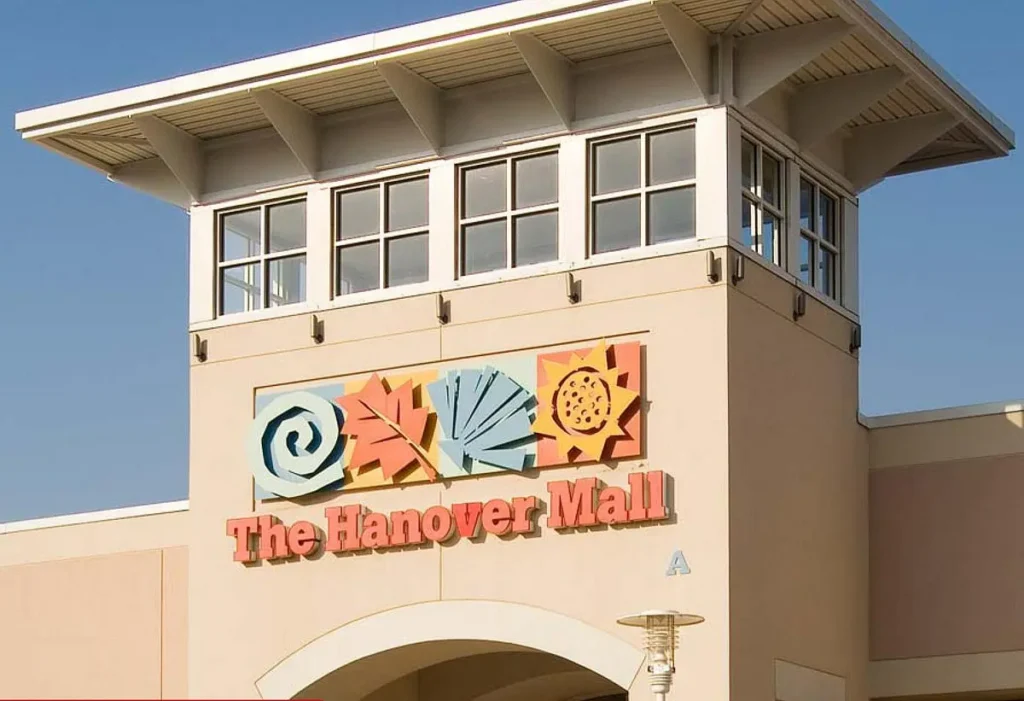 Exterior of North Hanover Mall with various stores and parking lot.