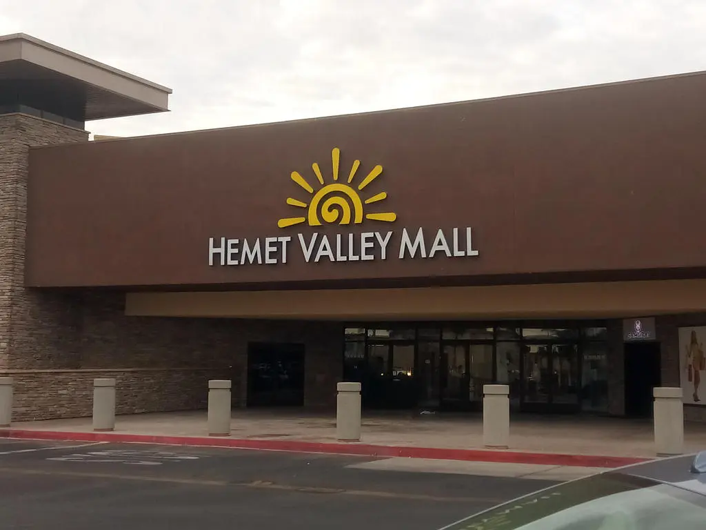 Hemet Valley Mall sign with palm trees and parking lot,