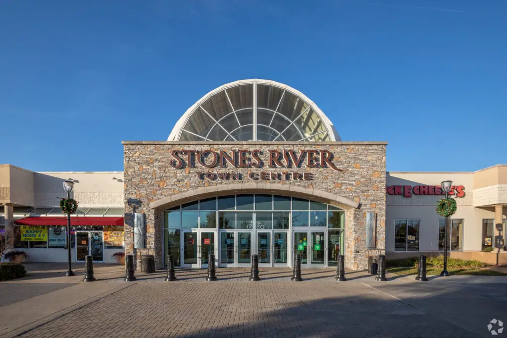 A bustling shopping center nestled by a serene river