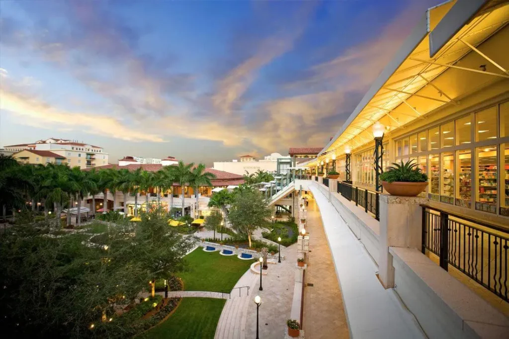 Shops at Merrick Park Mall with palm trees and people walking around.